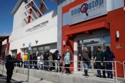 People wait in line for help with unemployment benefits at the One-Stop Career Center in Las Vegas, March 17, 2020.