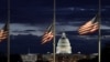 With the U.S. Capitol in the distance, flags fly at half-staff at the Washington Monument on the National Mall following the death of former U.S. President Jimmy Carter, in Washington, Dec. 30, 2024. 