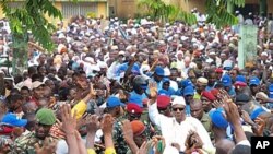 Guinea president elect Alpha Conde is surrounded by supporters in Conakry, Guinea, (file)