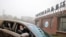 FILE - Peter Daszak and Thea Fischer, members of the World Health Organization team tasked with investigating the origins of the coronavirus disease, sit in a car arriving at Wuhan Institute of Virology in Wuhan, China, Feb. 2, 2021.