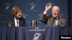 Former U.S. President Jimmy Carter gestures as he answers questions during "A Conversation with the Carters," as wife Rosalynn Carter looks on during the annual public event at The Carter Center in Atlanta, Georgia.