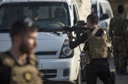 Members of the special forces of the Kurdish-led Syrian Democratic Forces (SDF) prepare to join the front against Turkish forces, near the northern Syrian town of Hasakeh, Oct. 10, 2019.