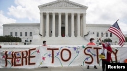 DACA recipients and their supporters celebrate outside the Supreme Court in Washington, June 18, 2020.