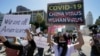 FILE - Protesters march at a rally against Asian hate crimes past the Los Angeles Federal Building in downtown Los Angeles, March 27, 2021.