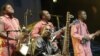 FILE - Toumani Diabaté (C) of Mali plays on his kora, an African harp, in Budapest, Aug. 11, 2006.