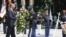 A member of an honor guard helps U.S. President Barack Obama (L) lay a wreath in honor of Memorial Day at the Tomb of the Unknowns in Arlington National Cemetery in Arlington, Virginia, May 28, 2012