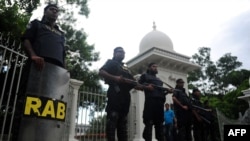 FILE - Members of the controversial Rapid Action Battalion (RAB) stand guard in front of the high court in Dhaka, Bangladesh, Aug. 1, 2013.