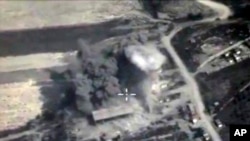 In this photo made from the footage taken from Russian Defense Ministry official web site on Sunday, Oct. 4, 2015, an aerial view of a bomb explosion in Syria.