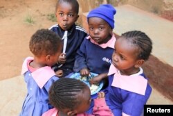 Girls and boys share a meal at the Makini Self-Help Primary School in Kibera, Nairobi, Kenya, Sept. 23, 2016.