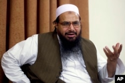 FILE - In this April 3, 2012, Hafiz Mohammed Saeed, chief of Jamaat-ud-Dawwa and founder of Lashkar-e-Taiba, talks with the Associated Press in Islamabad, Pakistan.