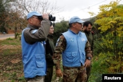 U.N. peacekeepers and Israeli soldiers look towards the border with Lebanon the morning after the Israeli military said it had launched an operation to "expose and thwart" cross-border attack tunnels from Lebanon, in Israel's northernmost town Metula, Dec. 5, 2018.