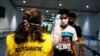 Health Quarantine officer checks people with a thermal scanner after Indonesia confirmed its first cases of coronavirus disease (COVID-19), in Soekarno Hatta International Airport, in Tangerang near Jakarta, Indonesia, March 6, 2020. 