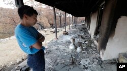 Justin Kam surveys his destroyed home at Balmoral, Australia, Jan. 7, 2020. 