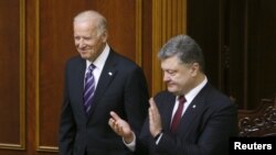 Ukraine's President Petro Poroshenko (R) greets U.S. Vice President Joe Biden at the parliament in Kyiv, Ukraine, Dec. 8, 2015.