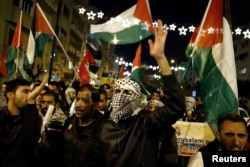 People take part in a protest against Donald Trump's decision to recognize Jerusalem as the capital of Israel, in Athens, Greece, Dec. 8, 2017.