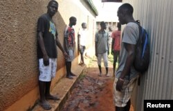 Residents gather to look at the footprints and traces of struggle, outside the house where an Italian volunteer lived before she was seized, in Chakama trading centre of Magarini, Kenya, Nov. 21, 2018.