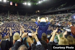 Students and their families celebrate graduation at Del Mar College in Corpus Christi, Texas.