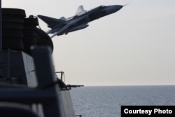 Image of Russian fly-over near guided-missile destroyer USS Donald Cook in Baltic Sea as provided by the U.S. Navy 6th Fleet.