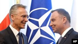 NATO Secretary General Jens Stoltenberg (L) shakes hands with Polish President Andrzej Duda prior to talks in Warsaw, Poland, May 28, 2018.