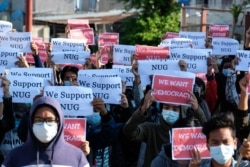 Protesters hold posters in support of the National Unity Government (NUG) during a demonstration against the military coup on "Global Myanmar Spring Revolution Day" in Taunggyi, Shan state on May 2, 2021.