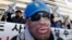A protester wearing a mask depicting former U.S. basketball star Dennis Rodman, attends a rally in central Seoul, South Korea, Jan.8, 2014, denouncing Rodman's visit to North Korea and North Korean leader Kim Jong Un on Kim's birthday. 