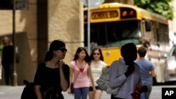 FILE - Students walk across a campus in Portland, Oregon.