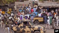 FILE - Nigerian soldiers patrol a market after recent violence in areas surrounding Maiduguri, Jan. 27, 2015.