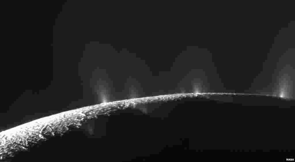 This Feb. 17, 2005 image made available by NASA shows plumes of water ice and vapor from the south polar region of Saturn's moon Enceladus. The activity is understood to originate from the moon's subsurface ocean of salty liquid water, which is venting into space.