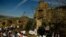 Devotees listen to mass accompanied by the three women known as ''La Mondidas'', during a religious pilgrimage in honor of Saint Bartholomew in the small village of Sarnago, northern Spain, Aug. 26, 2018.