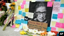 FILE - A memorial to U.S. Supreme Court Justice Ruth Bader Ginsburg includes a photograph of the late Justice, Sept. 22, 2020, outside the Harvard Law School library at Langdell Hall, on the campus of Harvard University, in Cambridge, Mass. 