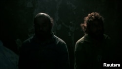 FILE - Prisoners that are said to be Islamic State fighters by Syrian Democratic Forces(SDF) fighters, are pictured north of Raqqa city, Syria, March 8, 2017. 