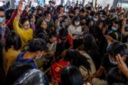 Mourners make the three-finger salute as they attend the funeral of a protester, who died amid a crackdown by security forces on demonstrations against the military coup, in Taunggyi in Myanmar's Shan state, March 29, 2021.