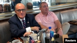 FILE - Rudy Giuliani is seen with Ukrainian-American businessman Lev Parnas at the Trump International Hotel in Washington, Sept. 20, 2019. Parnas has been arrested with another associate of Giuliani's, Igor Fruman, a Belarus-born U.S. citizen.
