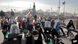 Iranians attend a rally marking the 42nd anniversary of the Islamic Revolution, at Azadi (Freedom) Square in Tehran, Iran, Feb. 10, 2021.