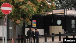 People wait in front of the visa application office entrance of the U.S. Embassy in Ankara, Turkey, Oct. 9, 2017. 
