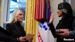 U.S. Attorney General Pam Bondi, left, swears in director of national intelligence Tulsi Gabbard in the Oval Office at the White House in Washington on Feb. 12, 2025.
