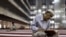 FILE - A man reads the Koran at Istiqlal mosque in Jakarta, July 24, 2012. 