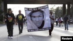 FILE - Demonstrators block traffic on a highway in Los Angeles as they protest the acquittal of George Zimmerman in the Trayvon Martin trial.