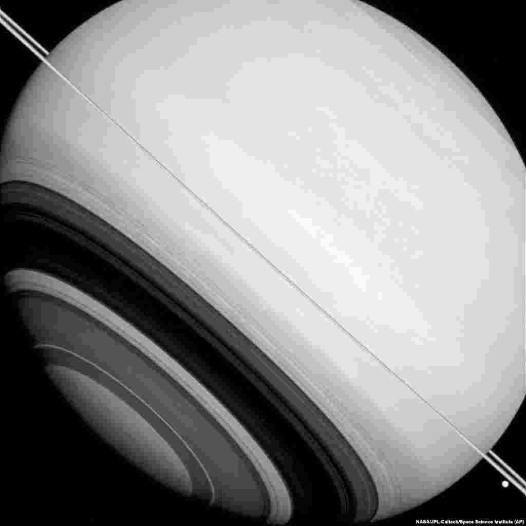 This Aug. 14, 2014 image made available by NASA shows shadows of Saturn's rings projected on the southern hemisphere of the gas giant.