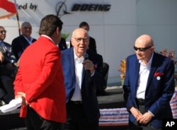Astronaut Jim Lovell, center, speaks, accompanied by fellow astronaut Tom Stafford, during the ribbon cutting ceremony for the "Heroes and Legends" exhibit at the Kennedy Space Center Visitor Complex in Florida, Nov. 11, 2016.