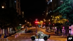 A military Humvee blocks an intersection along K Street in downtown Washington as demonstrators protest the death of George Floyd, June 1, 2020, in Washington. 