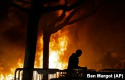 A fire set by demonstrators protesting a scheduled speaking appearance by Breitbart News editor Milo Yiannopoulos, burns on the University of California at Berkeley campus in February 2017.