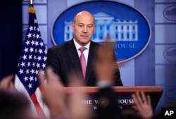 White House chief economic adviser Gary Cohn watches as reporters raise their hands to ask questions during the daily press briefing in the Brady press briefing room at the White House, in Washington, Jan. 23, 2018.