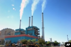 FILE - Smoke rises from the Colstrip Steam Electric Station, a coal burning power plant in in Colstrip, Mont.