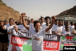 FILE - Supporters celebrate as they welcome Merera Gudina, leader of the Oromo Federalist Congress party, after his release from prison in Addis Ababa, Ethiopia, Jan. 17, 2018.