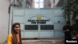 Formin Akter, a Rohingya refugee girl, stands outside the gates of the Asian University for Women on her first day of college in Chittagong, Bangladesh Aug. 26, 2018. 