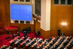 FILE - A video screen shows the results of the vote on a piece of national security legislation concerning Hong Kong during the closing session of China's National People's Congress (NPC) in Beijing, May 28, 2020.