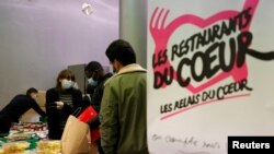 Students get food during a distribution organized by the French charity "Les Restos du Coeur" (Restaurants of the Heart) at a student residence in Paris, France, Feb. 16, 2021.