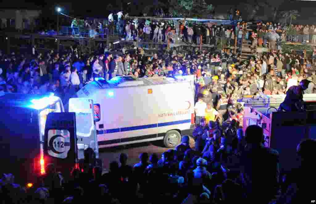 Medics, ambulances and relatives are seen at the entrance of a coal mine hours after a deadly explosion and fire in Soma, western Turkey, May 13, 2014.