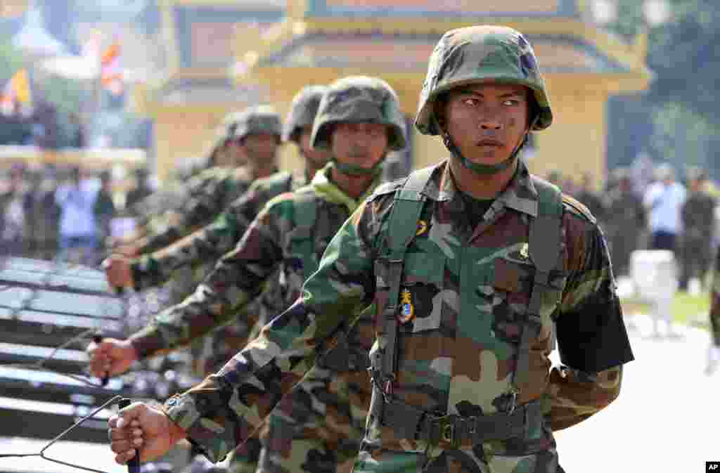 Cambodian Army soldiers practice how to fire artillery launchers in front of Royal Palace ahead of the funeral for former King Norodom Sihanouk January 31, 2013, in Phnom Penh, Cambodia.